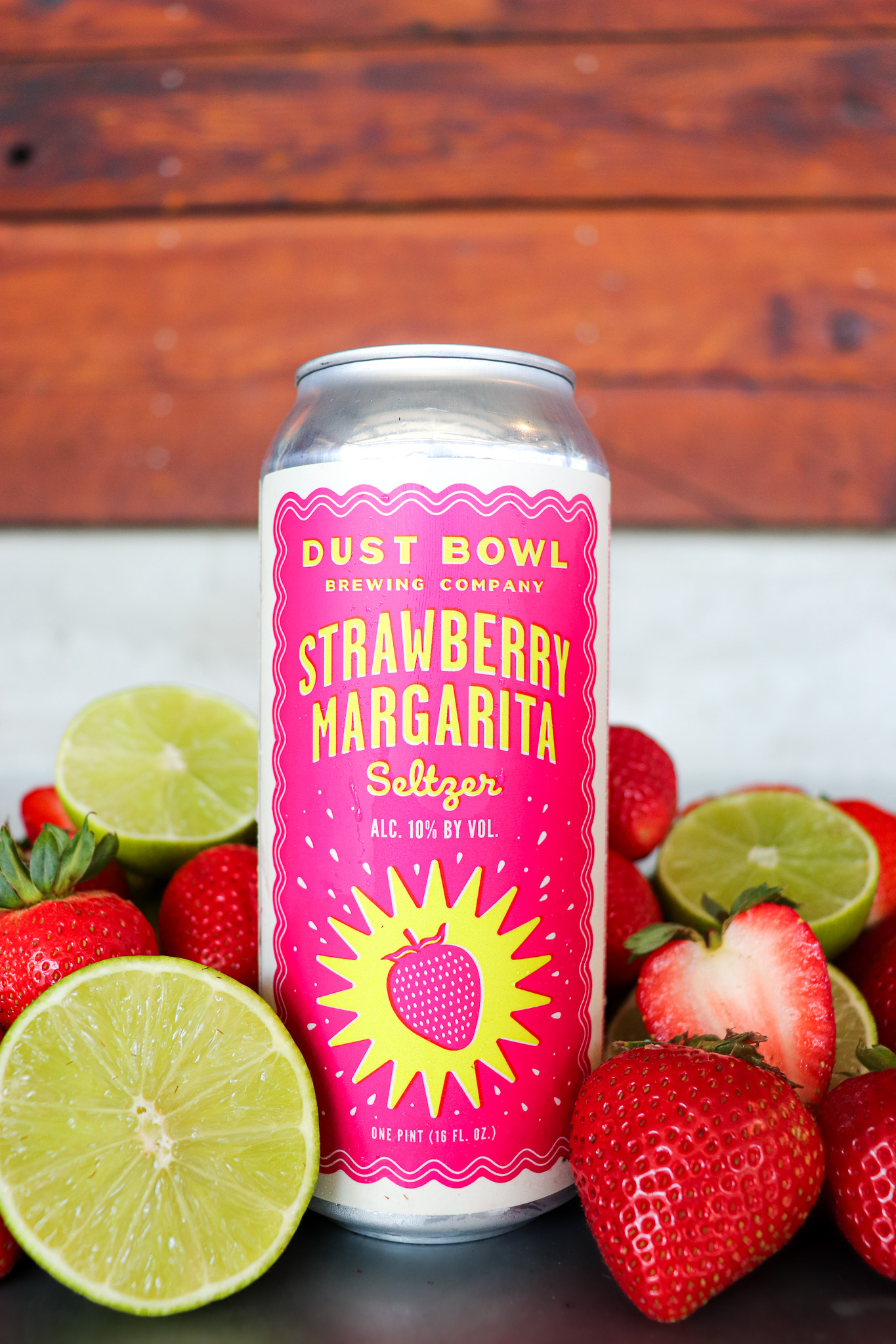 Strawberry Margarita Can with limes and strawberries